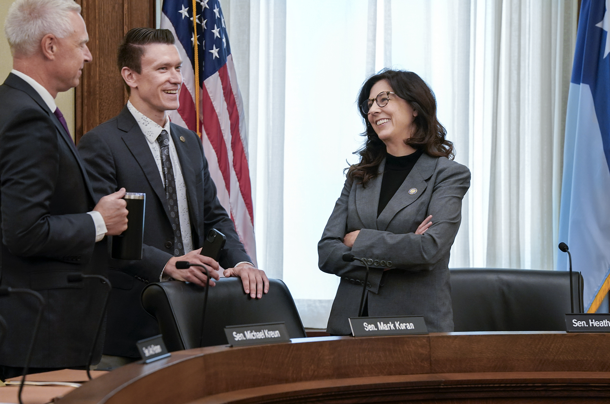 Rep. Matt Norris, center, speaks with Sen. Heather Gustafson and Sen. Michael Kreun Wednesday before the first meeting of the Legislative Inspector General Advisory Commission. (Photo by Michele Jokinen)